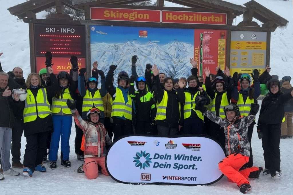 Skigruppe vor Skikarte im Skigebiet